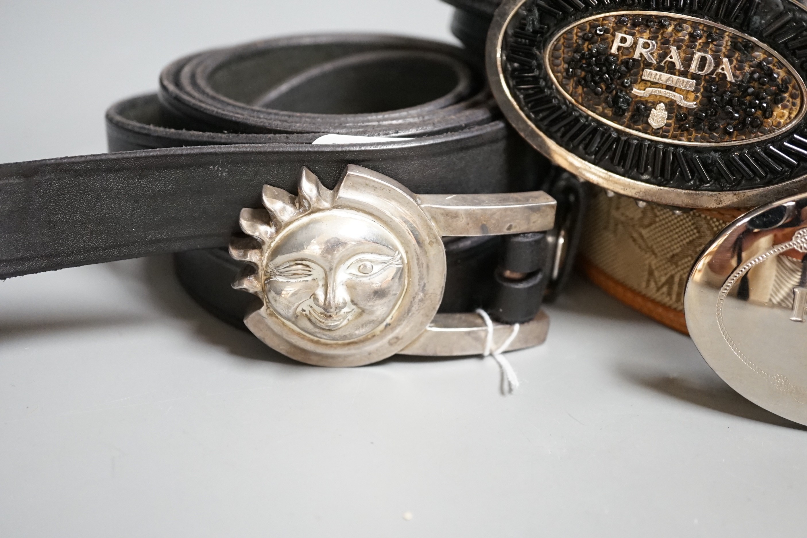 Five assorted belts including Prada (2) and Versace (2)